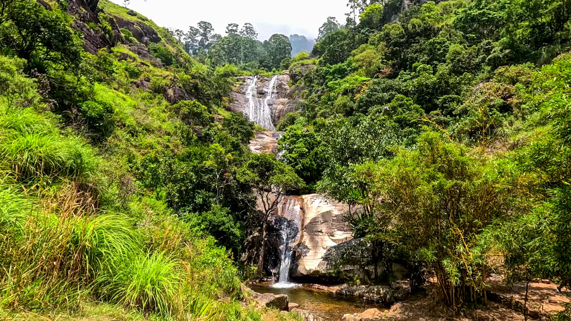 Nonpareil Estate Falls cascading through tea estate landscape in Ratnapura District
